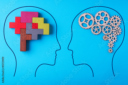 Human brain is made gear mechanism and colourful shapes on blue background. Two different thought processes.