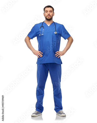 healthcare, profession and medicine concept - doctor or male nurse in blue uniform with stethoscope over white background © Syda Productions