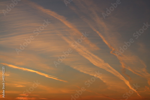 evening sky with red clouds, airplane trails