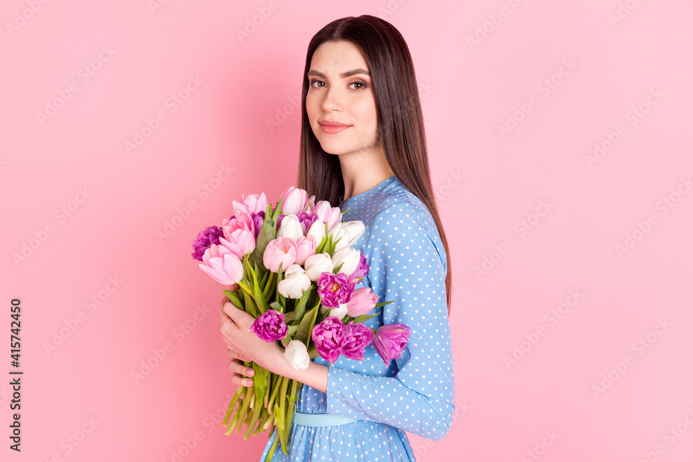 Photo of young beautiful charming pretty smiling girl look camera hold bouquet flowers isolated on pink color background