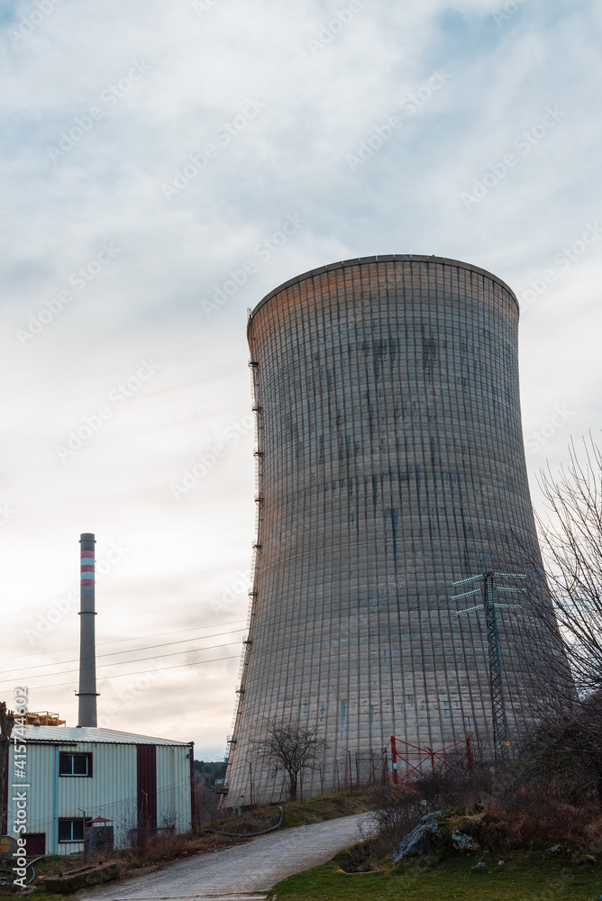 cooling tower of a thermoelectric plant in the process of dismantling near a town cooling tower of a thermoelectric plant in the process of dismantling near a town