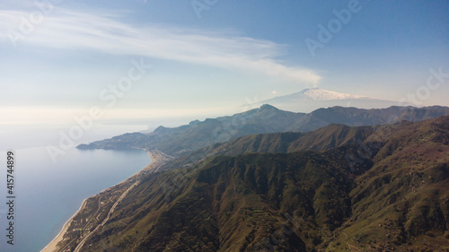 Aerial view from the north of the Etna volcano and the Ionian coast