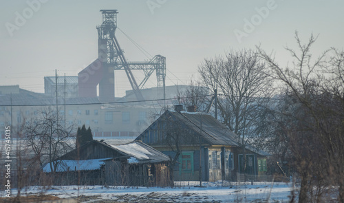 village house on the background of an industrial factory.