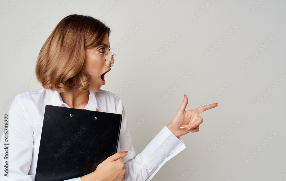 Business woman in glasses with documents in hands on a gray background Copy Space Business woman in glasses with documents in hands on a gray background Copy Space