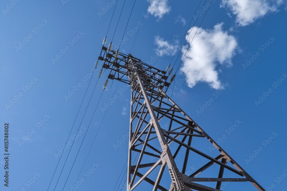 High voltage towers with sky background. High voltage electric pole with cloudy sky. Electric pole on cloudy sky background.