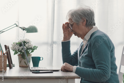 фотографія Senior woman having a bad headache