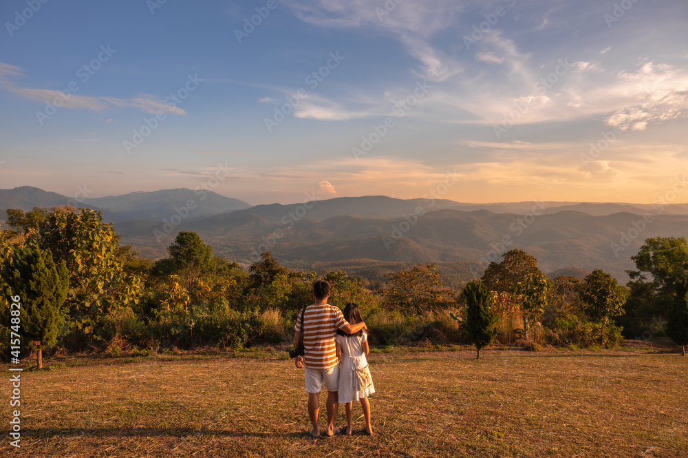 Happy love family, Father and daughter hugging at sunset with amazing mountain view, Chiang Mai, Thailand.