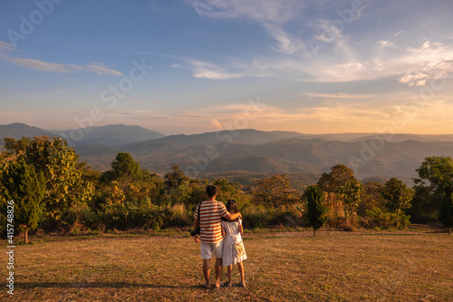 Happy love family, Father and daughter hugging at sunset with amazing mountain view, Chiang Mai, Thailand.