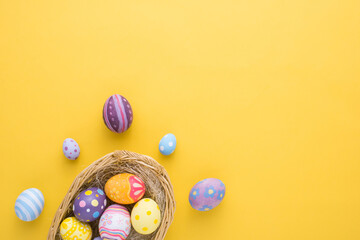 Happy Easter day decoration colorful eggs in nest on paper background with copy space