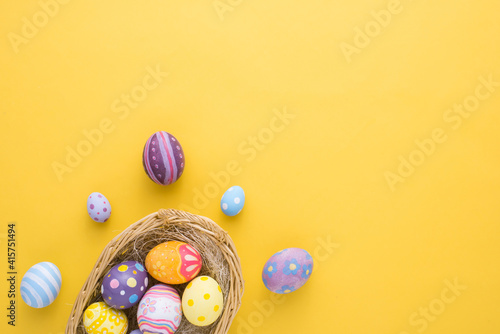 Happy Easter day decoration colorful eggs in nest on paper background with copy space photo