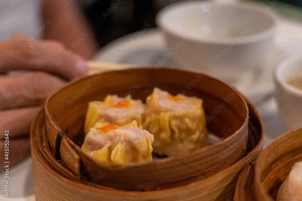 Siu Mai dumplings in bamboo steamer in yum cha Chinese restaurant Siu Mai dumplings in bamboo steamer in yum cha Chinese restaurant