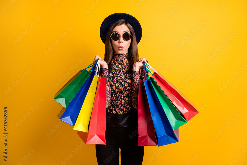Portraitf of shocked person hold bags lips staring dark headwear retro clothing isolated on yellow color background