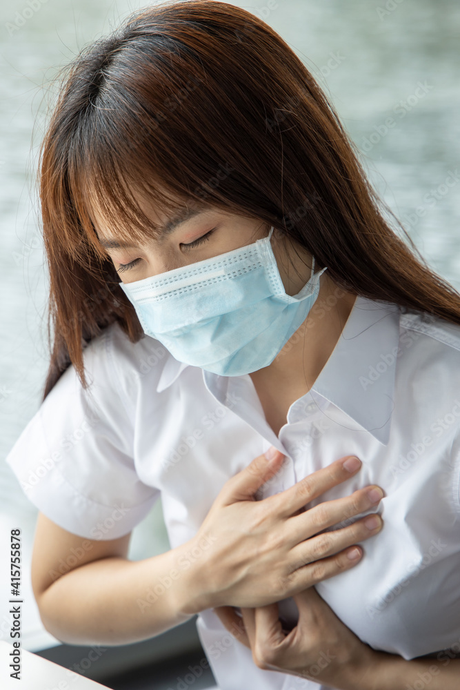 Sick, not vaccinated asian woman wearing mask suffering from COVID-19 coronavirus symptoms shortness of breath Sick, not vaccinated asian woman wearing mask suffering from COVID-19 coronavirus symptoms shortness of breath