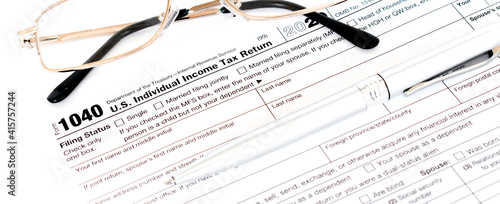 US tax form 1040 with a silver pen and glasses