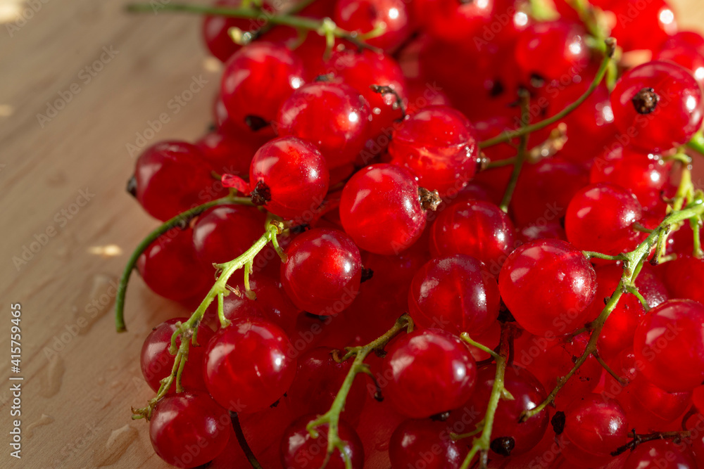Red currant berries on a light wooden background. Selective focus The concept of healthy berries. Red currant berries on a light wooden background. Selective focus The concept of healthy berries.