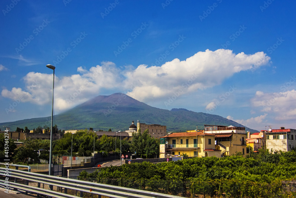 Amazing view of Mount Vesuvius on the road from Naples to Pompeii. Campania, southern Italy. The active cone is the high peak on the left side. Soft selective focus, long exposure