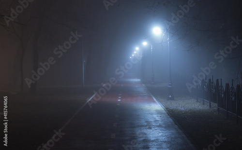 blue lantern lights on the alley in the fog © serikbaib