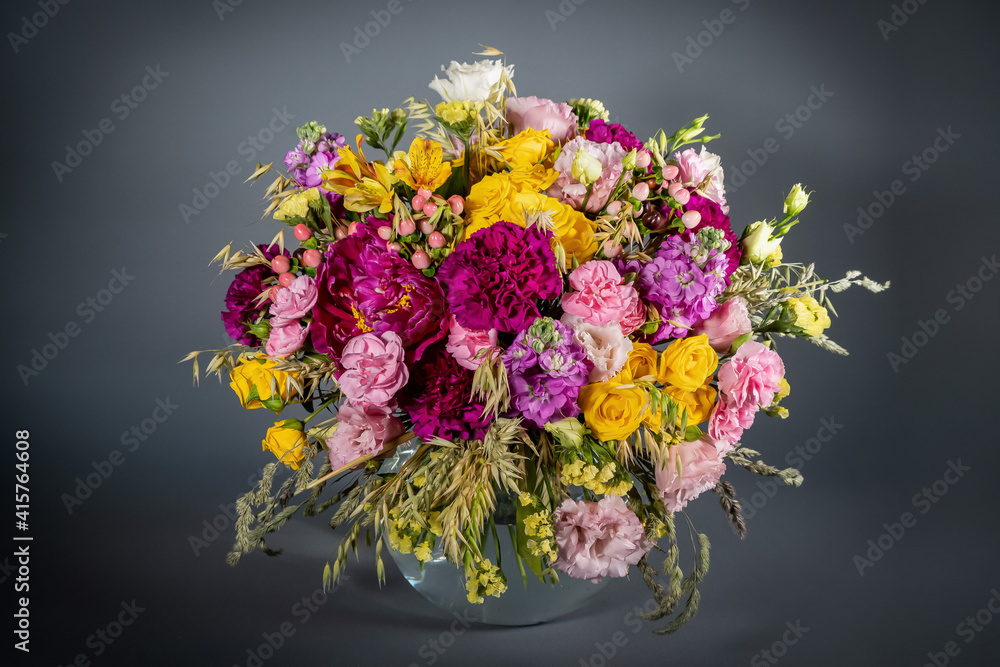 Close up wedding bouquet of flowers Isolated on a gray background. Delicate bouquet in pastel colors. Summer flowers