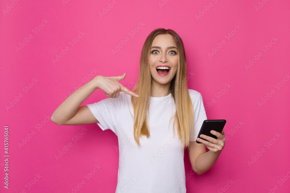 Happy Young Woman Is Pointing At Telephone And Shouting Happy Young Woman Is Pointing At Telephone And Shouting