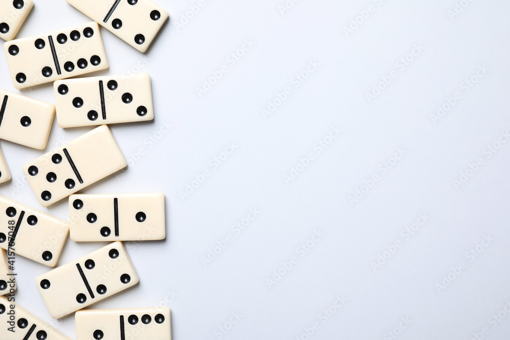 Classic domino tiles on white background, flat lay. Space for text Classic domino tiles on white background, flat lay. Space for text