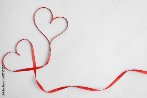 Hearts made of red ribbon on white background, top view. Valentine's day celebration © New Africa