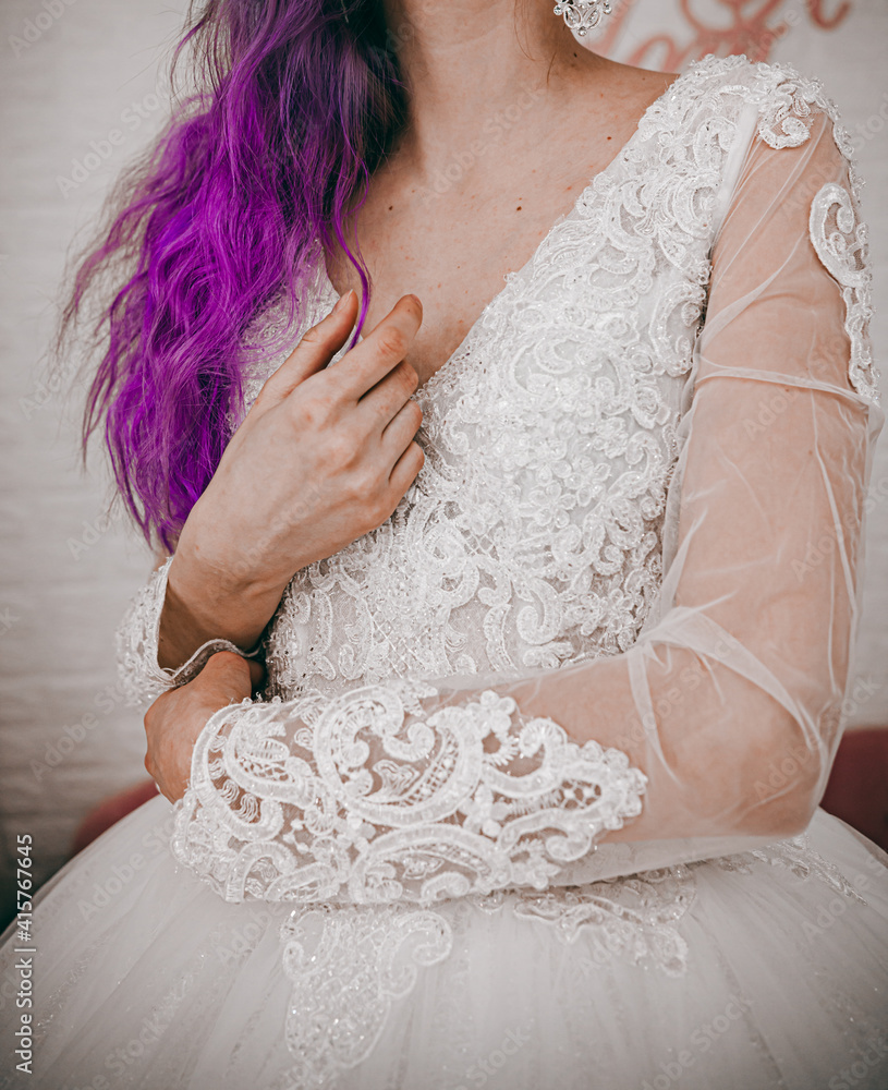 beautiful bride with purple hair picks up her wedding dress