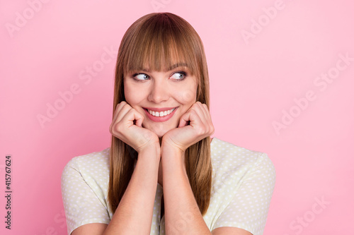 Portrait of attractive cute cheerful curious girl looking aside thinking isolated over pink pastel color background