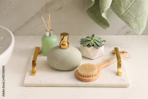 Air reed freshener, toiletries and plant on countertop in bathroom
