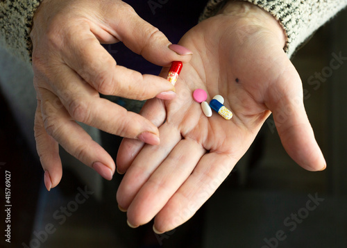 Close up photo of a drugs in old woman's hands.