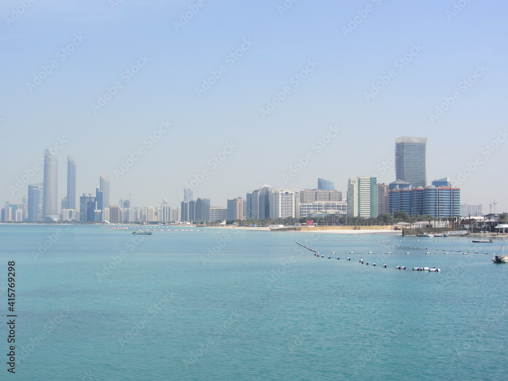 beach and sea with tall buildings