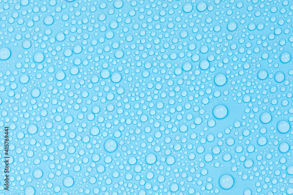 Water drops on blue background texture. Backdrop glass covered with drops of water. bubbles in water