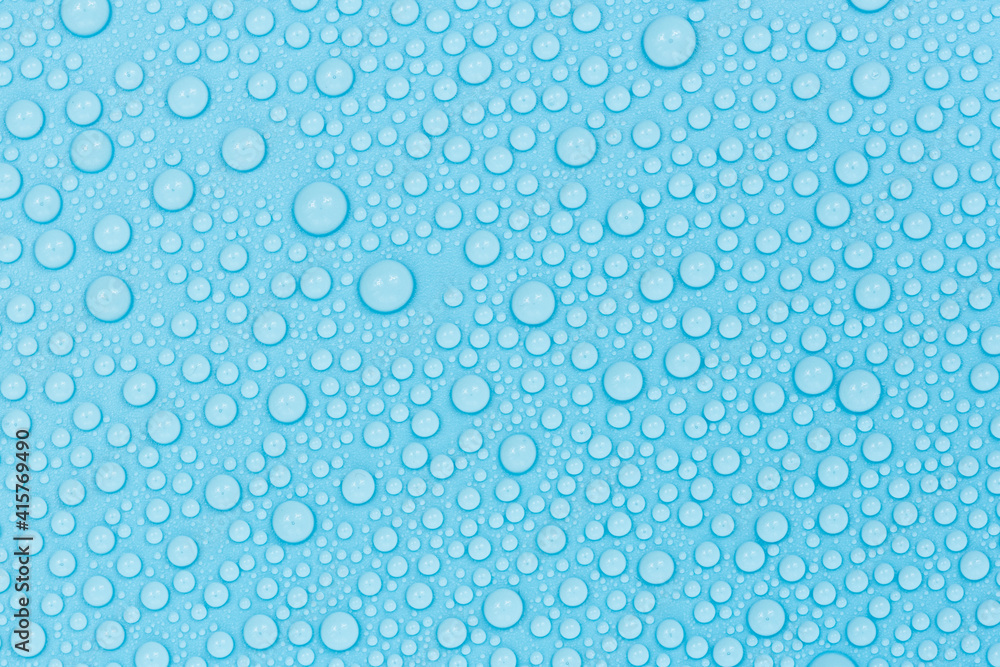 Water drops on blue background texture. Backdrop glass covered with drops of water. bubbles in water