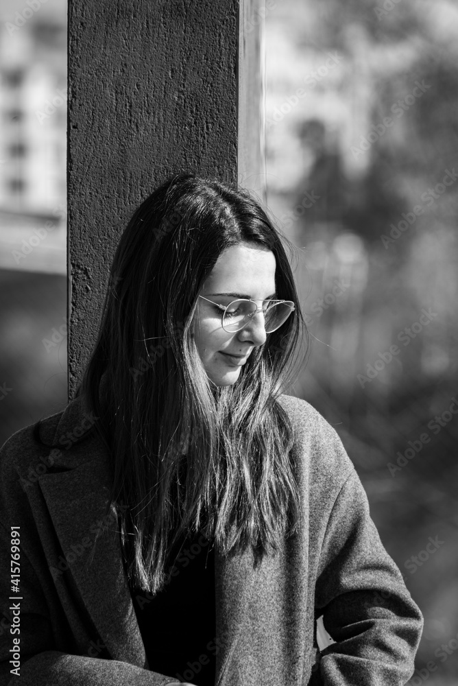 Beautiful young woman with glasses in a park. Black and white photo Beautiful young woman with glasses in a park. Black and white photo
