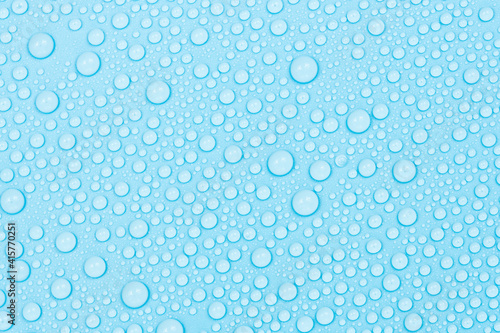 Water drops on blue background texture. Backdrop glass covered with drops of water. bubbles in water