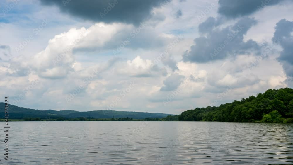 A time-lapse of a beautiful lake in the wilderness with a sky full of puffy clouds. A time-lapse of a beautiful lake in the wilderness with a sky full of puffy clouds.