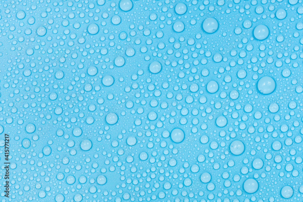 Water drops on blue background texture. Backdrop glass covered with drops of water. bubbles in water