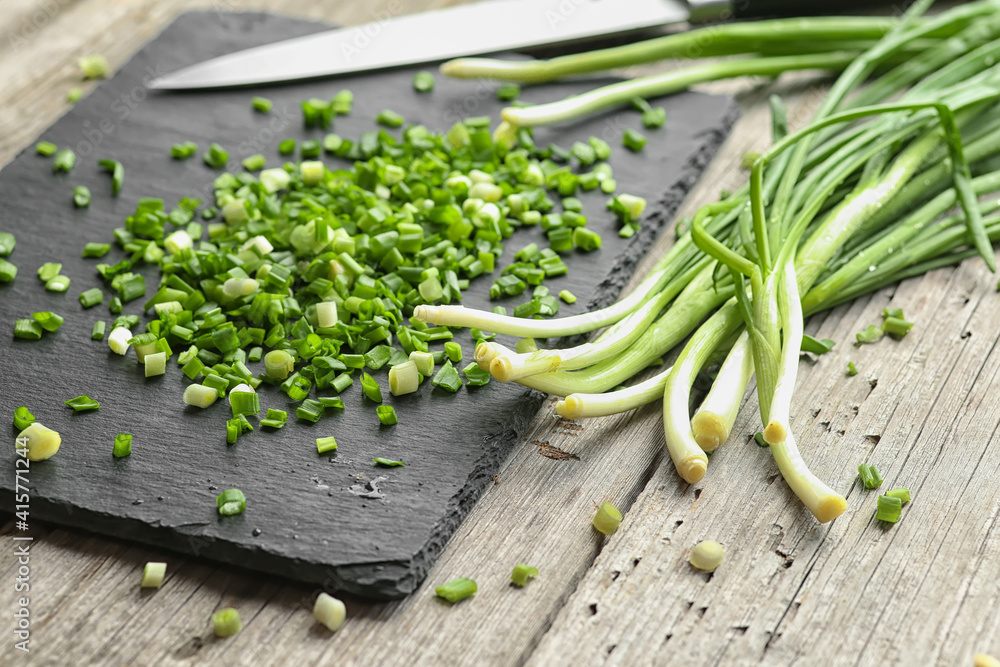 Green onion on wooden cutting board Green onion on wooden cutting board