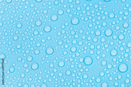 Water drops on blue background texture. Backdrop glass covered with drops of water. bubbles in water