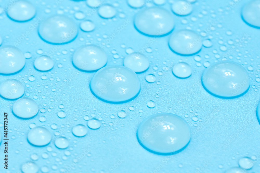 Water drops on blue background texture. Backdrop glass covered with drops of water. bubbles in water