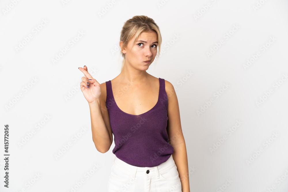 Young Russian woman isolated on white background with fingers crossing and wishing the best Young Russian woman isolated on white background with fingers crossing and wishing the best