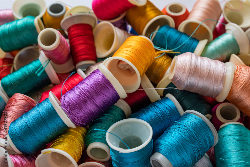 Colored thread spools used in the fabric and textile industry Colored thread spools used in the fabric and textile industry