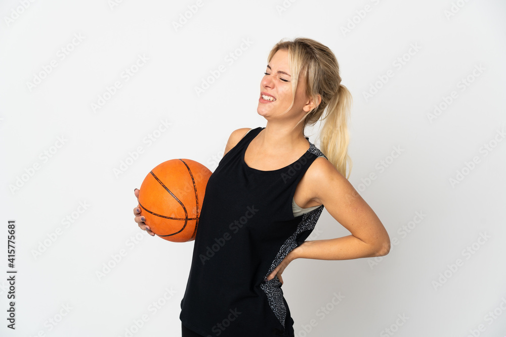 Young Russian woman playing basketball isolated on white background suffering from backache for having made an effort Young Russian woman playing basketball isolated on white background suffering from backache for having made an effort