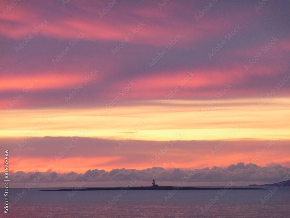 Dramatic sunset over Lady Isle lighthouse off Troon Ayrshire