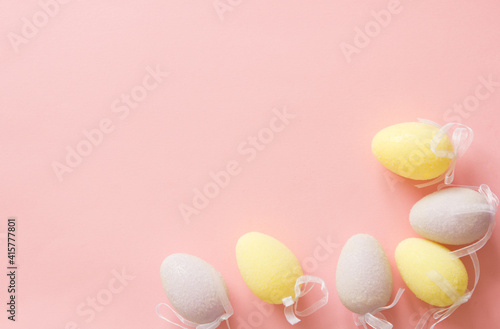 Pink and purple decorative eggs on a pink background. Copy space. FLATLAY. background for design. Easter background. Festive decor.