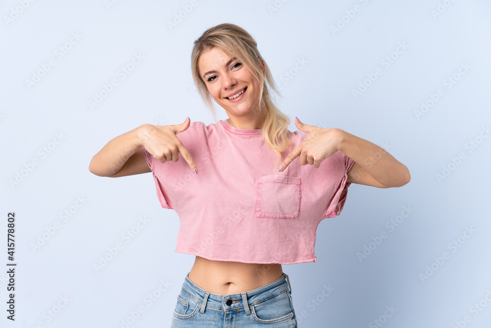 Blonde woman over isolated blue background proud and self-satisfied Blonde woman over isolated blue background proud and self-satisfied
