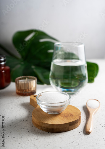 selective focus. Collagen powder in a glass container. light background. copyspace. Extra protein intake. Natural beauty and Health supplement for skin, bones, joints and intestines