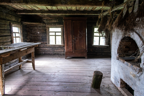 Interior of wooden countryside old house with rustic oven © benevolente