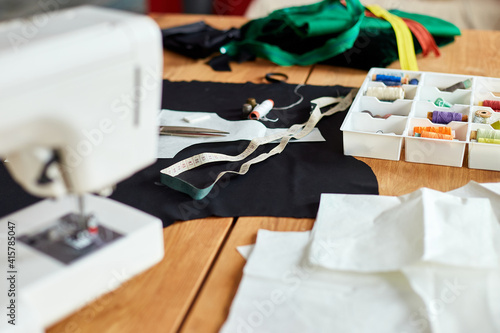 Sewing supplies and machine on a wooden table