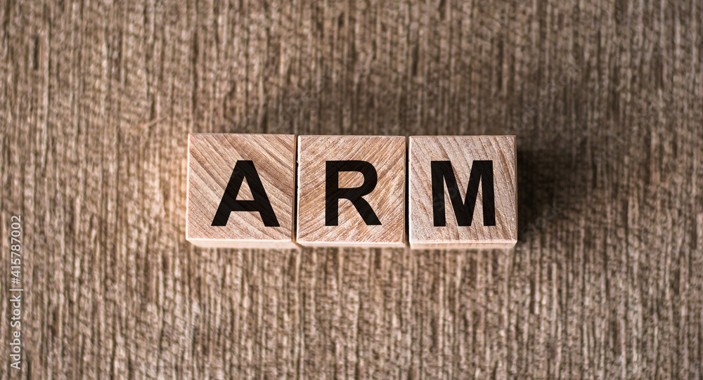 ARM (Advanced RISC Machines) word written on wooden blocks on a brown background. ARM (Advanced RISC Machines) word written on wooden blocks on a brown background.