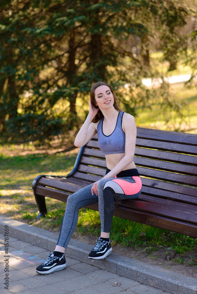Young female workout before fitness training session at the park. Healthy young woman warming up. Young female workout before fitness training session at the park. Healthy young woman warming up.